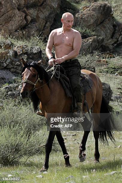 Russian Prime Minister Vladimir Putin rides a horse during his vacation outside the town of Kyzyl in Southern Siberia on August 3, 2009. AFP PHOTO /...