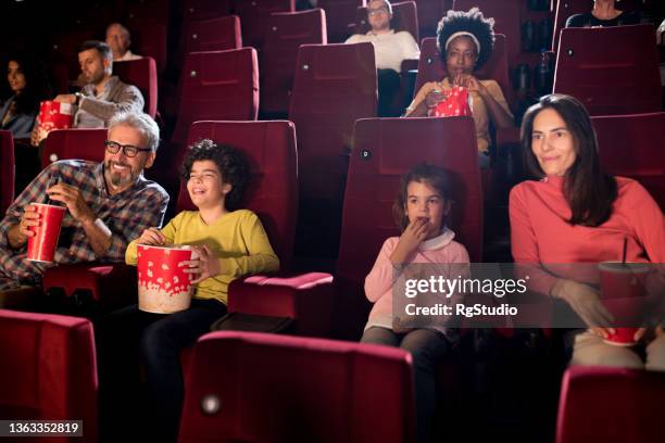 family enjoying at the movie theater - good boy premiere stock pictures, royalty-free photos & images