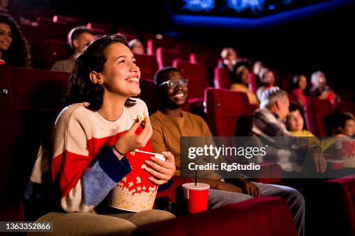 映画館でコメディ映画を楽しむ友人 映画館でコメディ映画を楽しむ友人