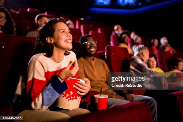 friends enjoying a comedy movie at the cinema - filmpremière stockfoto's en -beelden