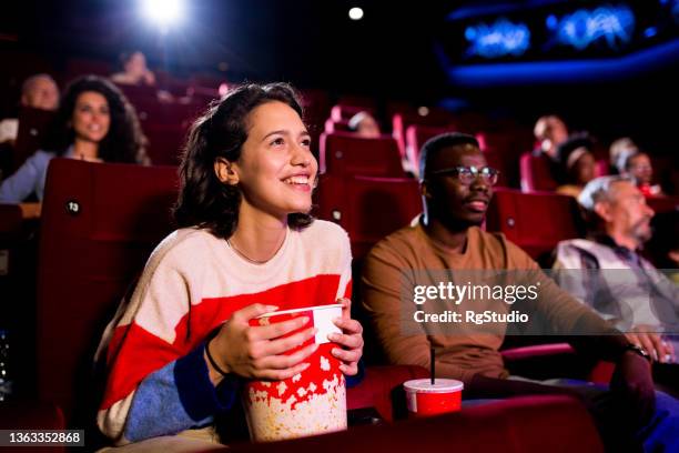 friends enjoying a comedy movie at the cinema - 50 watching video stock pictures, royalty-free photos & images