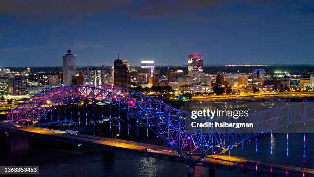 light show on the hernando de soto bridge at night with downtown memphis beyond - tennessee stock pictures, royalty-free photos & images