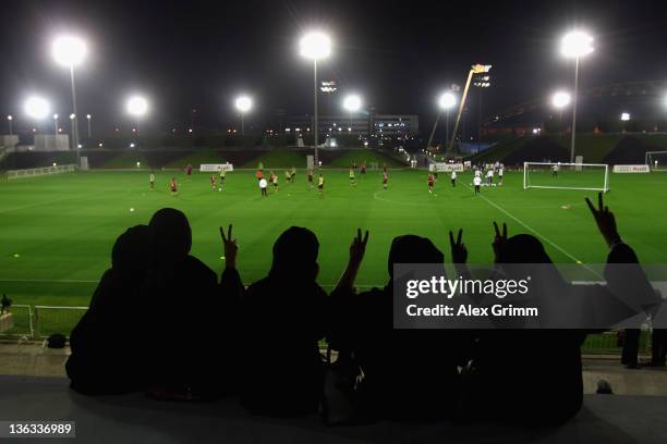 Women in traditional clothes pose during a training session of Bayern Muenchen at the ASPIRE Academy for Sports Excellence on January 2, 2012 in...