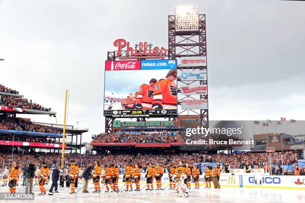 The Philadelphia Flyers and the New York Rangers line up for the National Anthem during the 2012 Bridgestone NHL Winter Classic at Citizens Bank Park...