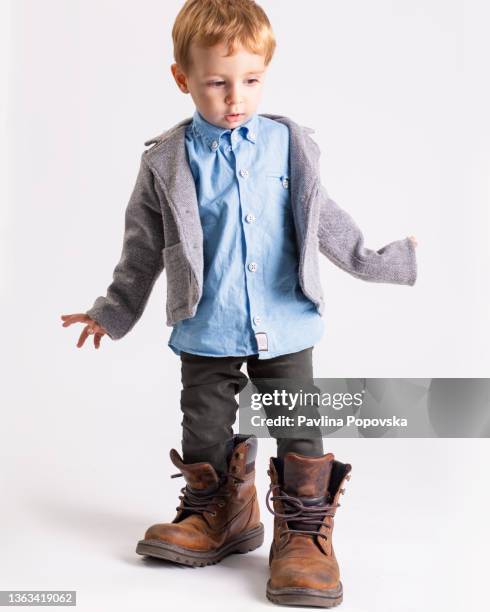 2 year old walking in his parent shoes - kid in big shoes stock pictures, royalty-free photos & images