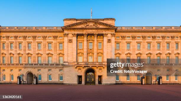 london buckingham palace ornate facade illuminated at sunrise panorama uk - buckingham palace gates stock pictures, royalty-free photos & images