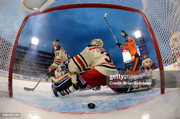 Henrik Lundqvist of the New York Rangers looks on after Brayden Schenn of the Philadelphia Flyers scores a second period goal during the 2012...