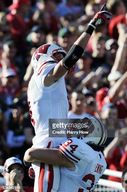 Wide receiver Jared Abbrederis of the Wisconsin Badgers celebrates with Bradie Ewing after Abbrederis scores on a 38-yard touchdown catch in the...