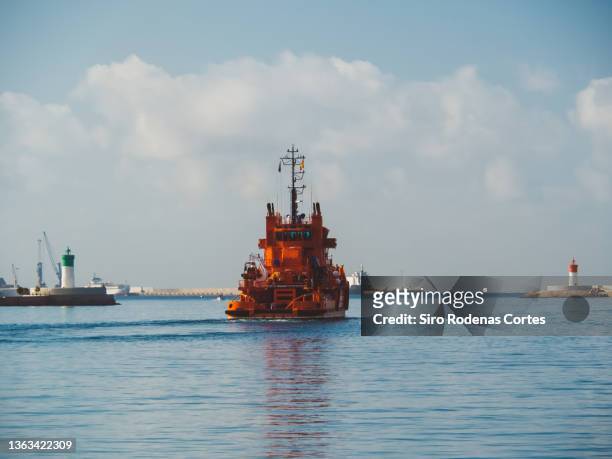 cartagena, spain - 08/14/2019: a ship of "salvamento marítimo" which in english means "security and maritime rescue" leaves the port of cartagena to the mediterranean sea - migrants rescued by the spanish maritime stock pictures, royalty-free photos & images