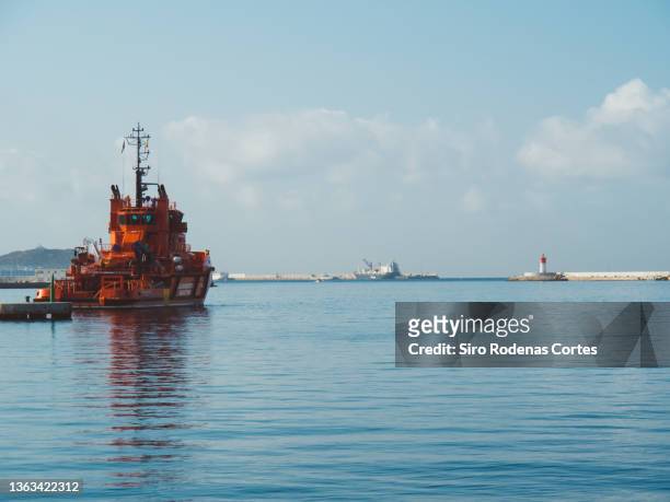cartagena, spain - 08/14/2019: a ship of "salvamento marítimo" which in english means "security and maritime rescue" leaves the port of cartagena to the mediterranean sea - anchored boats stock pictures, royalty-free photos & images