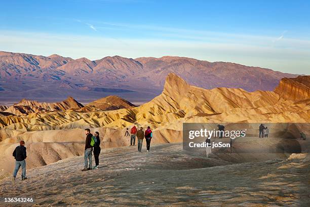 people watching sunrise at zabriskie point - zabriskie point stock pictures, royalty-free photos & images