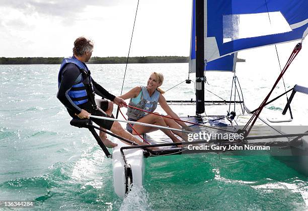 mature couple sailing boat - catamaran race photos et images de collection