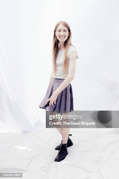 portrait of cheerful young woman standing against white background - skirt isolated stock pictures, royalty-free photos & images