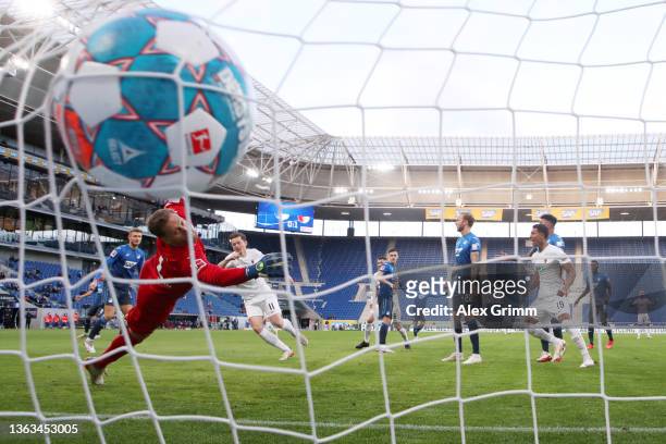 Michael Gregoritsch of FC Augsburg scores their team's first goal past Oliver Baumann of TSG 1899 Hoffenheim during the Bundesliga match between TSG...