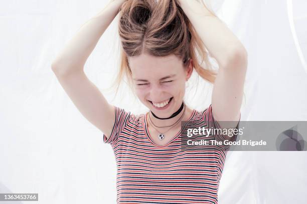 happy young woman playing with hair - short necklace fotografías e imágenes de stock