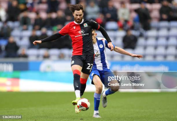 Ben Brereton of Blackburn Rovers is pressured by Kelland Watts of Wigan Athletic during the Emirates FA Cup Third Round match between Wigan Athletic...