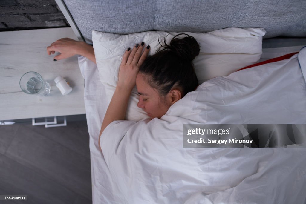 Brunette sleeping in modern bedroom