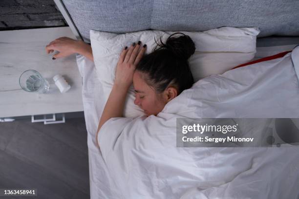 brunette sleeping in modern bedroom - chignon stock pictures, royalty-free photos & images