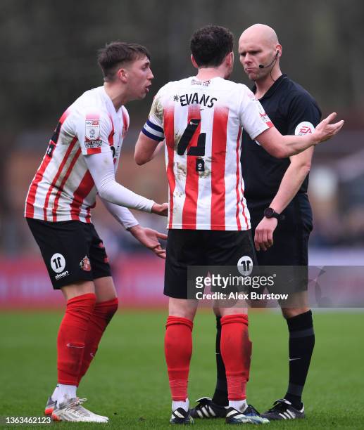 Dan Neil and Corry Evans of Sunderland react to Match Referee Charles Breakspear during the Sky Bet League One match between Wycombe Wanderers and...