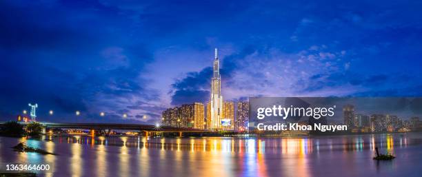 sunset view at landmark 81 - it is a super tall skyscraper and saigon bridge with development buildings along saigon river light smooth down - vietnam stock pictures, royalty-free photos & images