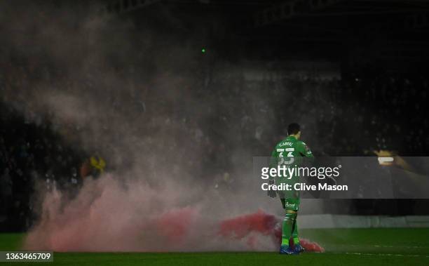 Rafael Cabral Barbosa of Reading removes a flare from the pitch during the Emirates FA Cup Third Round match between Kidderminster Harriers and...