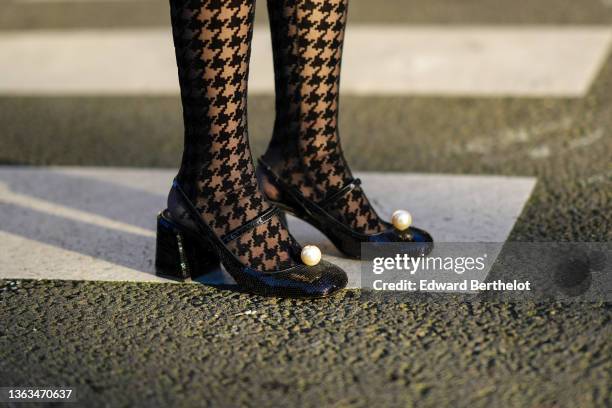 Gabriella Berdugo wears a Miu Miu total look, black houndstooth pattern printed tights, black shiny sequined shoes with pearl inserts, during a...