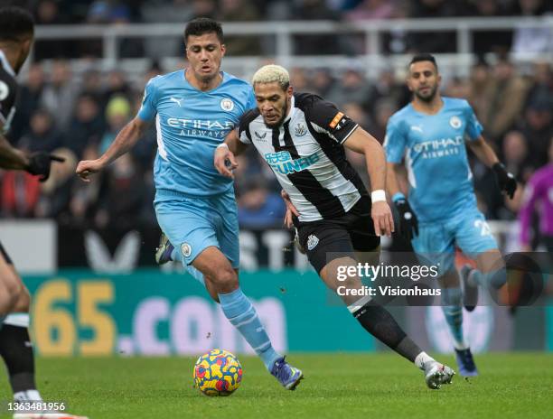 Joelinton of Newcastle United and Rodri of Manchester City in action during the Premier League match between Newcastle United and Manchester City at...