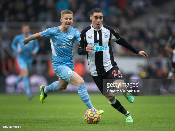 Miguel Almirón of Newcastle United and Oleksandr Zinchenko of Manchester City in action during the Premier League match between Newcastle United and...