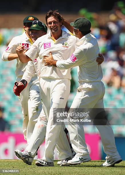 Ben Hilfenhaus of Australia celebrates with hius team mates after taking the wicket of Ravichandran Ashwin of India during day one of the Second Test...