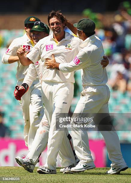 Ben Hilfenhaus of Australia celebrates with hius team mates after taking the wicket of Ravichandran Ashwin of India during day one of the Second Test...