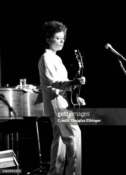 American Folk and Pop musician Janis Ian plays guitar as she performs onstage at an unspecified venue, East Lansing Michigan, August 3, 1981.