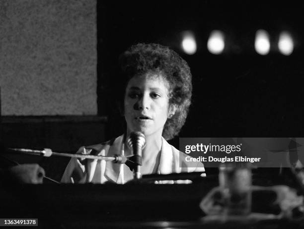 American Folk and Pop musician Janis Ian plays piano as she performs onstage at an unspecified venue, East Lansing Michigan, August 3, 1981.