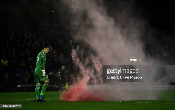 Rafael Cabral Barbosa of Reading removes a flare from the pitch during the Emirates FA Cup Third Round match between Kidderminster Harriers and...