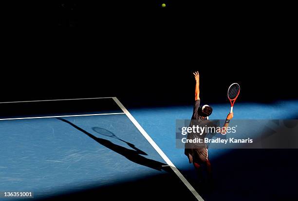 Marinko Matosevic of Australia serves against Tommy Haas of Germany during day three of the 2012 Brisbane International at Pat Rafter Arena on...