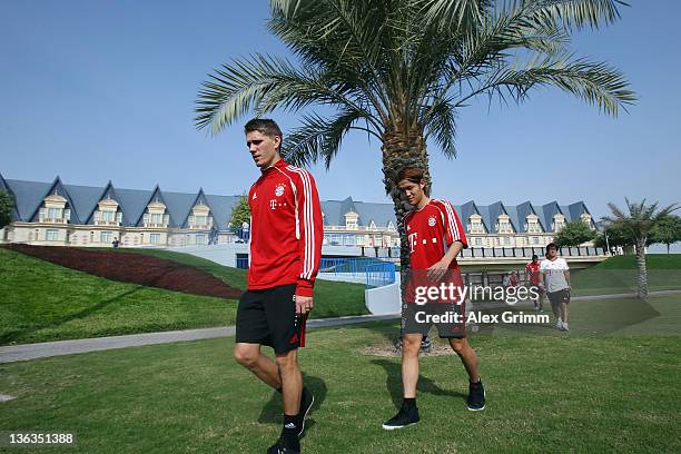 Nils Petersen and Takashi Usami arrive for a training session of Bayern Muenchen at the ASPIRE Academy for Sports Excellence on January 3, 2012 in...