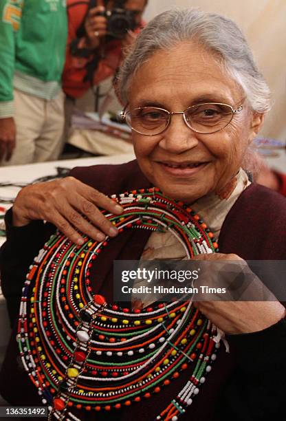 Delhi Chief Minister Sheila Dikshit views beaded jewelry after inaugurating the 25th Annual Dastkari Haat Craft Bazaar at Dilli Haat in New Delhi,...