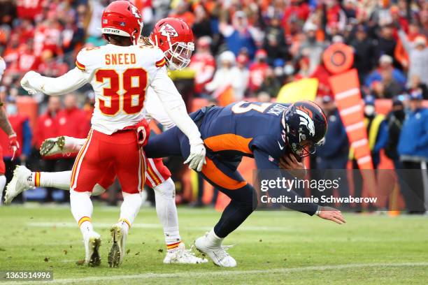 Drew Lock of the Denver Broncos rushes for a touchdown during the second quarter ahead of L'Jarius Sneed of the Kansas City Chiefs at Empower Field...