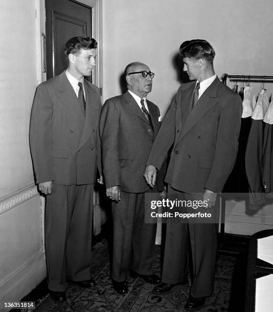 England football team members Roy Bentley and Jimmy Dickinson being fitted for summer suits by a tailor prior to flying to Rio de Janeiro for the...