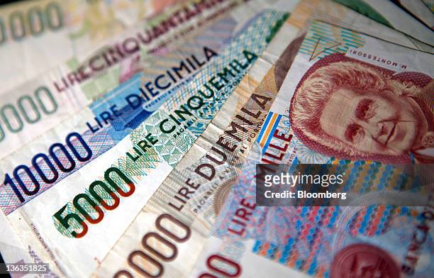 Mixed denominations of Lire notes, Italy's former currency, are seen in this arranged photograph in Rome, Italy, on Sunday, Jan. 1, 2012. Prime...