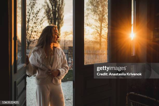 woman walking near traditional italian house. - cardigan stock-fotos und bilder