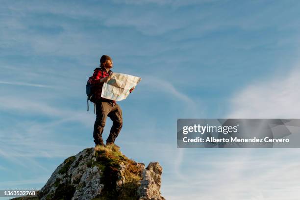 man with backpack on a rock - pilgrims stock-fotos und bilder