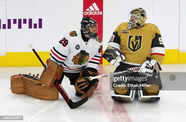 Marc-Andre Fleury of the Chicago Blackhawks and Robin Lehner of the Vegas Golden Knights talk as the former Vegas teammates warm up before their game...