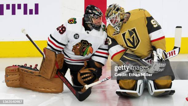 Marc-Andre Fleury of the Chicago Blackhawks and Robin Lehner of the Vegas Golden Knights talk as the former Vegas teammates warm up before their game...