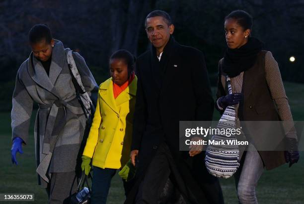 President Barack Obama , first lady Michelle Obama , and their daughters Sasha and Malia arrive at the White House on January 3, 2012 in Washington,...