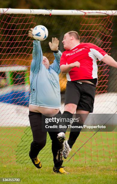 Goalkeeping action during a Sunday League Football match on the Racecourse in Northampton, England, 5th September 2009.