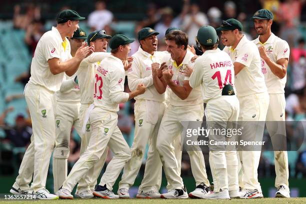 Pat Cummins of Australia celebrates with his team after claiming the wicket of Jos Buttler of England during day five of the Fourth Test Match in the...