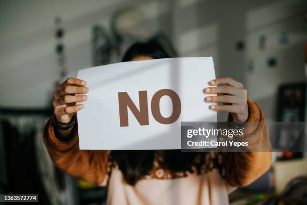 female holding paper with word no written - stop stock-fotos und bilder