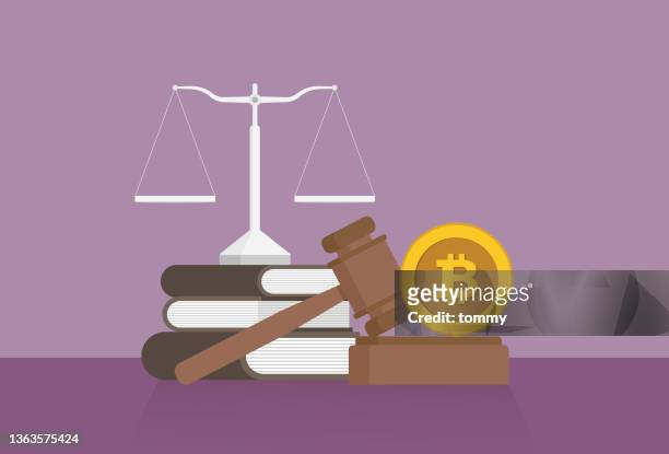 stockillustraties, clipart, cartoons en iconen met equal-arm balance, a book, a gavel, and a cryptocurrency coin on a table - digitale portemonnee