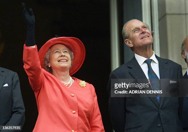 Queen Elizabeth II and Prince Philip look up from the balcony of Buckingham Palace as Concorde flies past during the Golden Jubilee celebrations in...