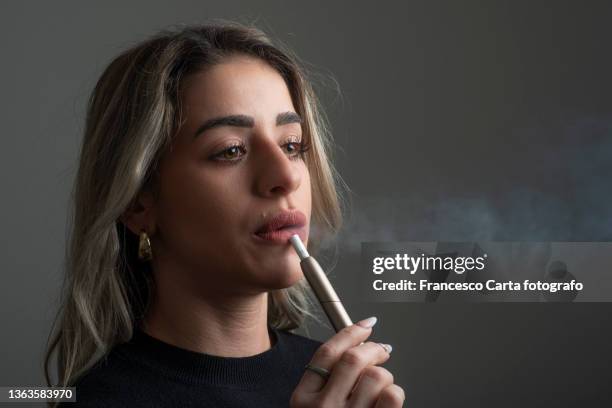 woman smoking electronic cigarette - vaping bildbanksfoton och bilder